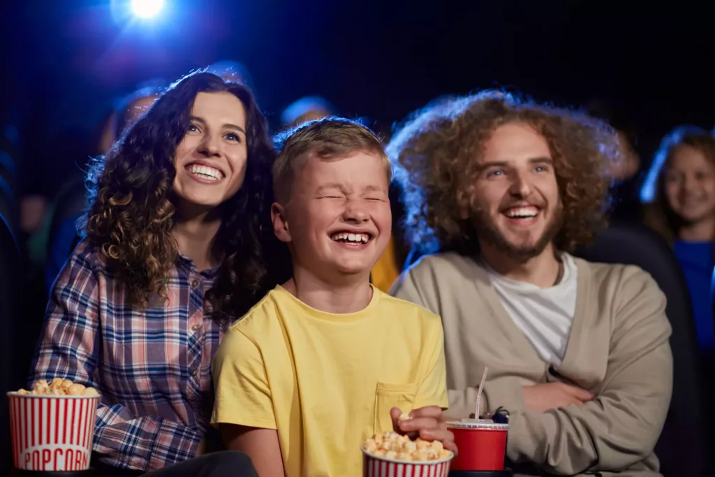 happy-family-with-son-watching-cartoon-in-cinema-2021-04-05-17-15-51-utc-scaled